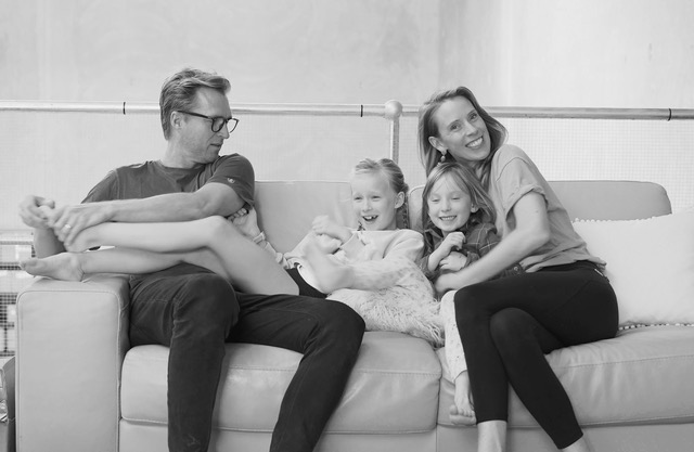 The Degraeve family smiles for a photo on the couch