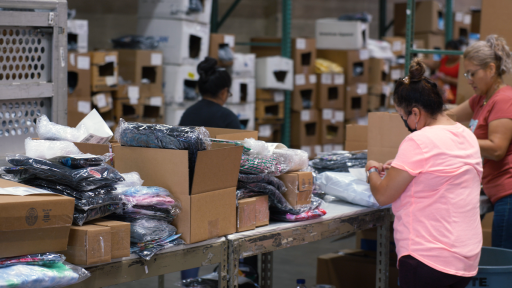 Photo of the fulfillment team packaging orders for Mighty Club